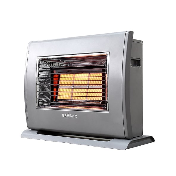 A silver space heater emits warmth, with visible glowing orange elements behind a protective grille, placed on a flat surface. The brand name 
