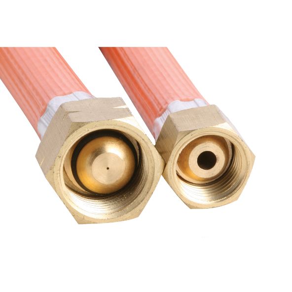Two brass gas fittings are shown, each attached to orange hoses. They are lying side by side against a plain white background.