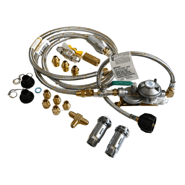 A collection of metal gas regulator components and hoses, with brass fittings and connectors, arranged on a white surface. Includes two labels with technical details and safety instructions.