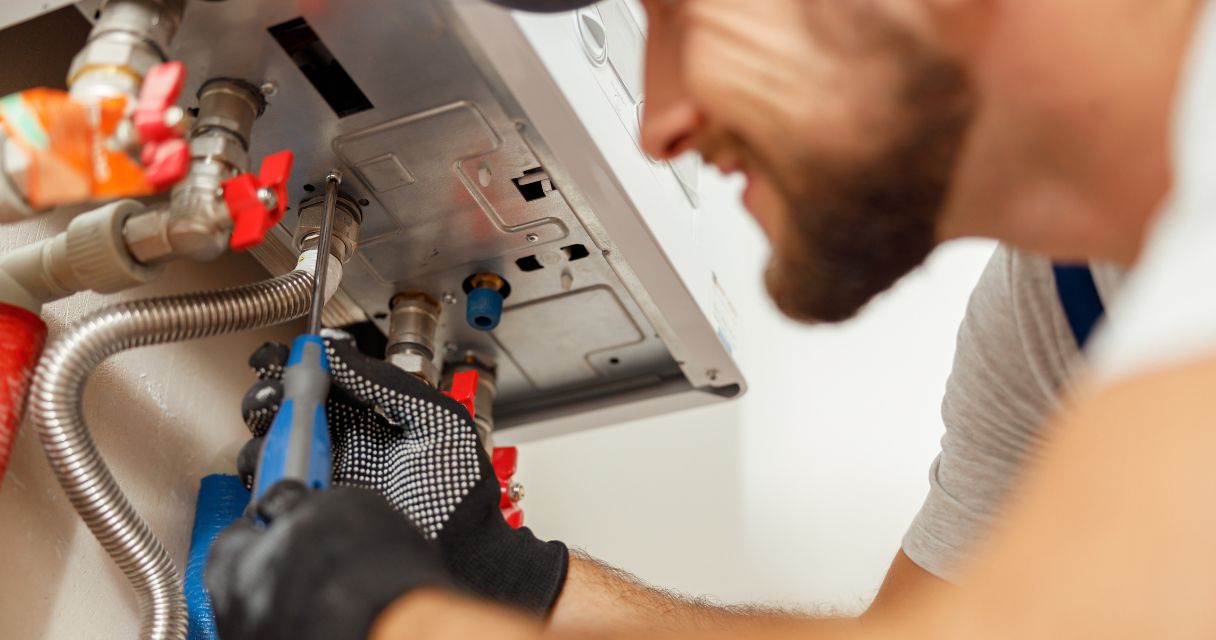 Plumber fixing electric hot water system